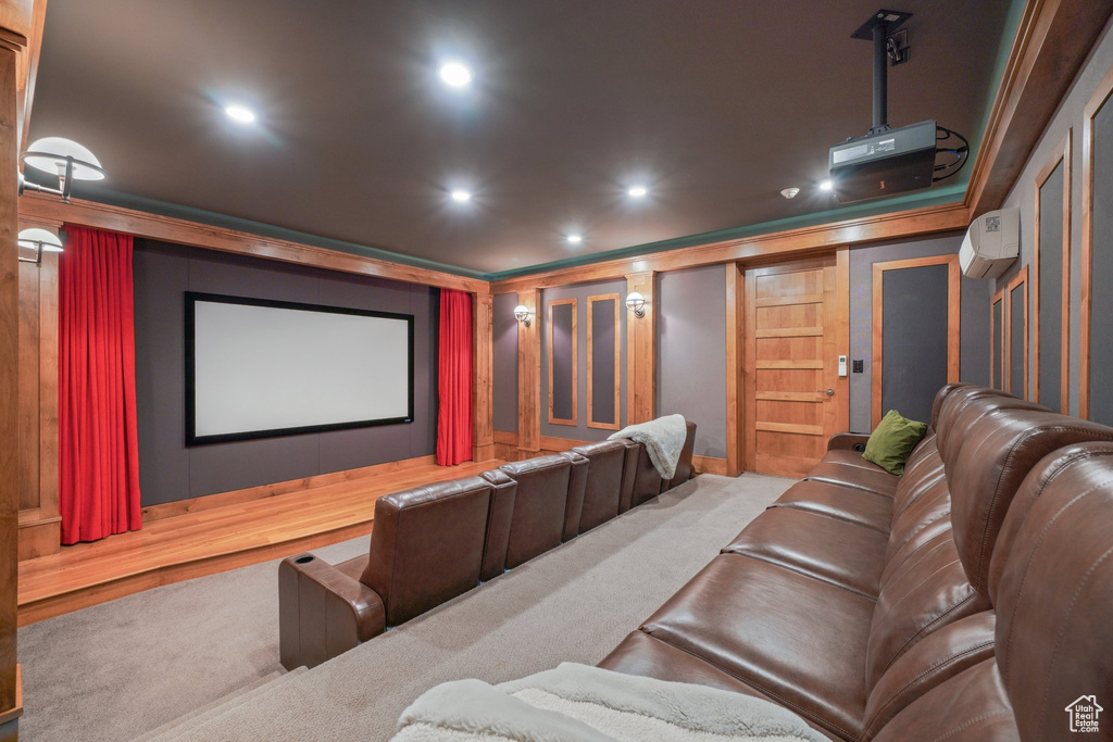 Carpeted cinema featuring a wall unit AC and recessed lighting