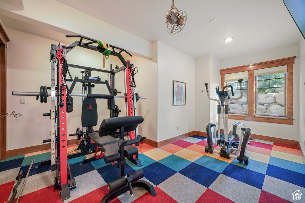 Exercise room featuring baseboards, tile patterned floors, and recessed lighting