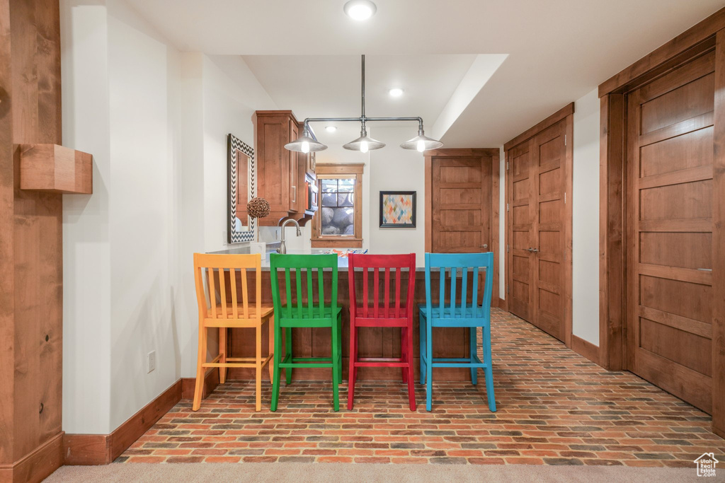 Dining room with baseboards, brick patterned floors, and recessed lighting