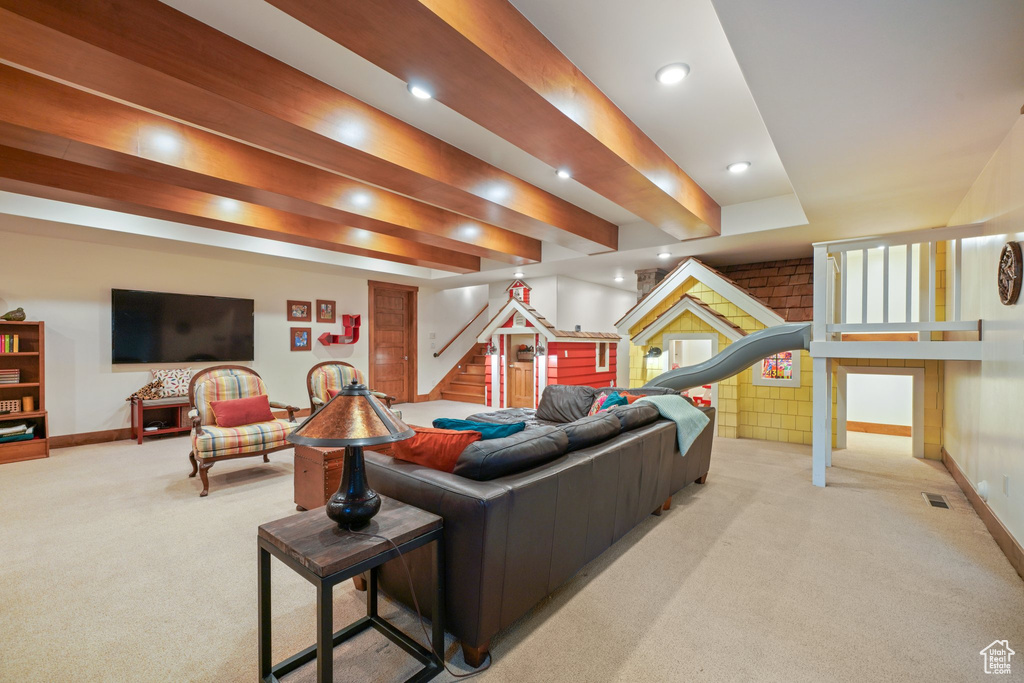 Carpeted living room featuring baseboards, stairs, recessed lighting, and visible vents