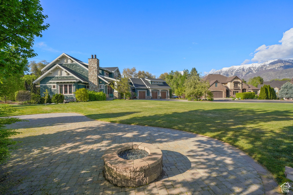 Surrounding community featuring a lawn and a mountain view