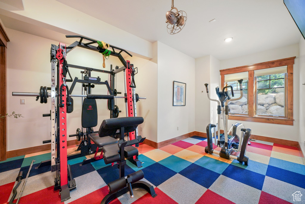 Workout room featuring baseboards, tile patterned floors, and recessed lighting