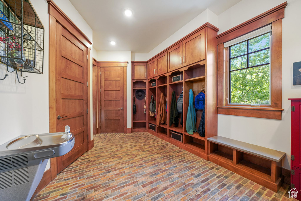 Mudroom with brick floor and recessed lighting