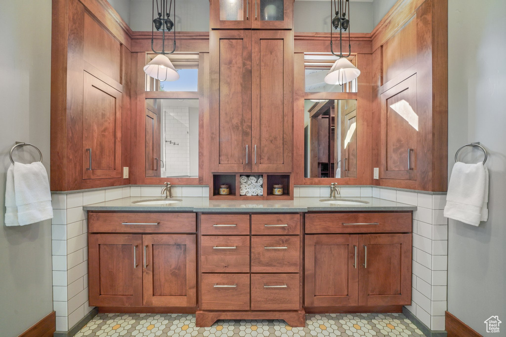 Bathroom featuring double vanity and baseboards
