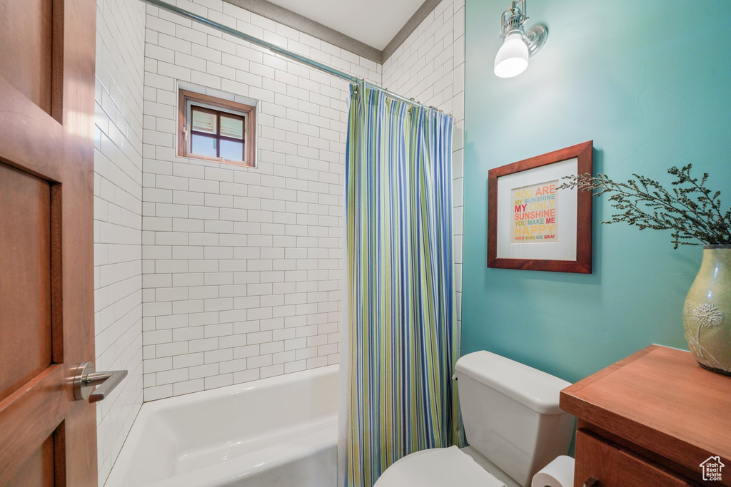 Bathroom featuring toilet and shower / bath combo