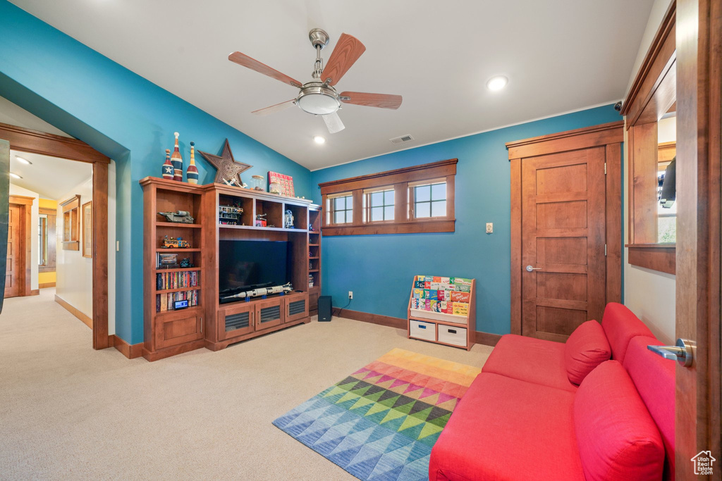 Carpeted living room featuring baseboards, recessed lighting, and a ceiling fan
