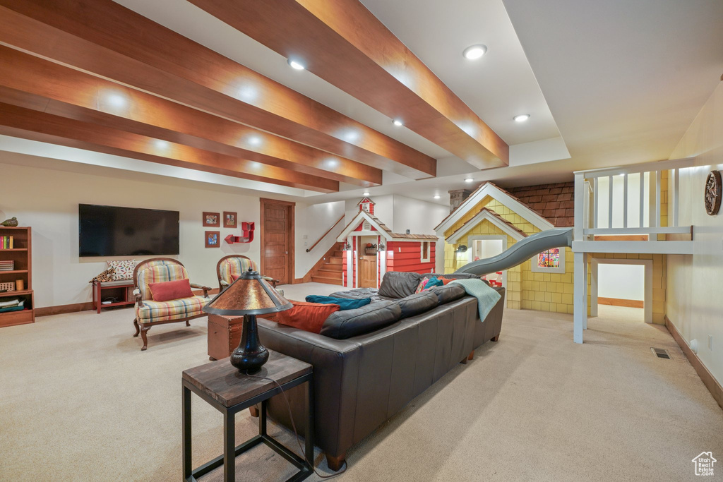 Carpeted living area featuring baseboards, stairs, and recessed lighting