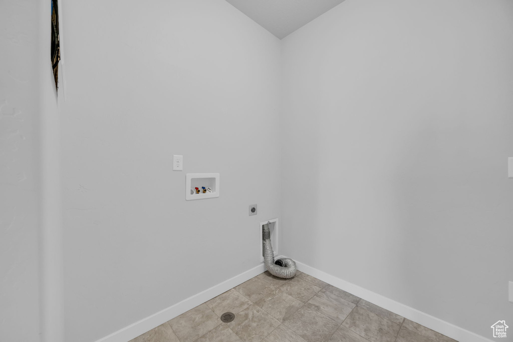 Laundry room featuring baseboards, hookup for an electric dryer, laundry area, and hookup for a washing machine