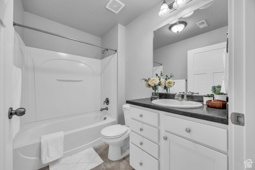 Full bath with toilet,  shower combination, vanity, and visible vents