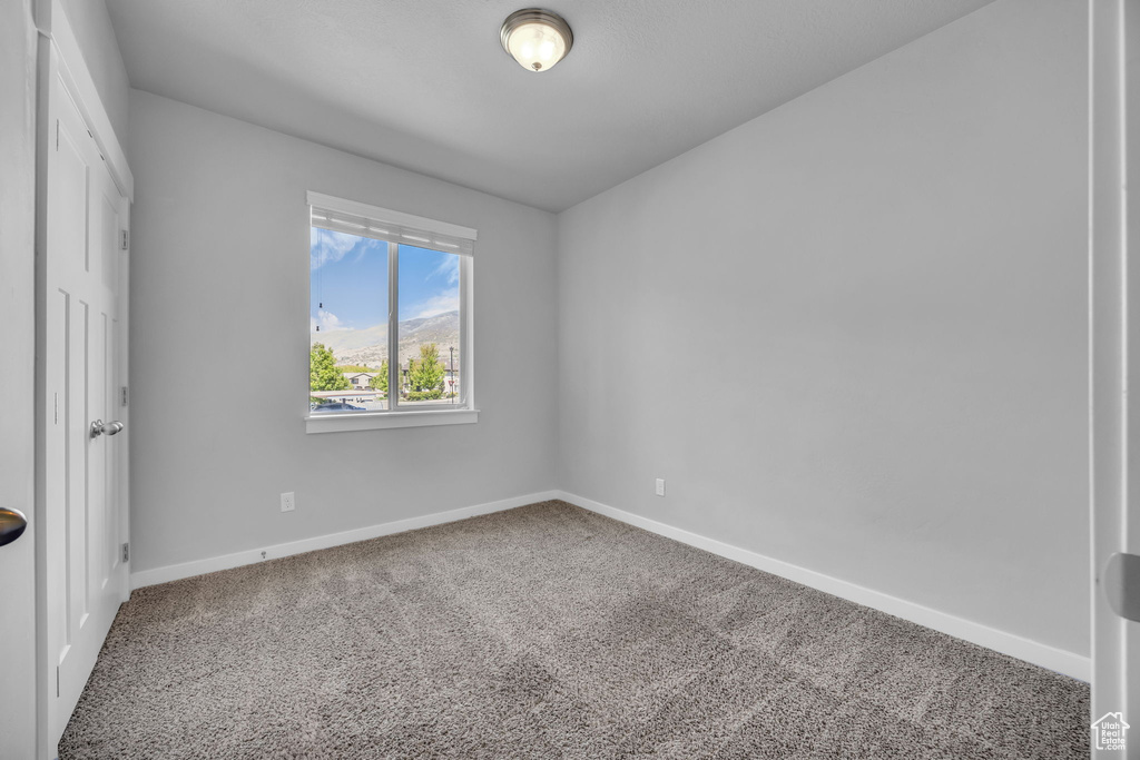 Unfurnished bedroom with carpet and baseboards