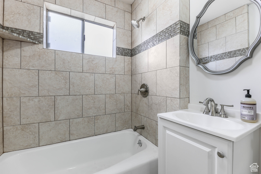 Bathroom featuring vanity and shower / tub combination