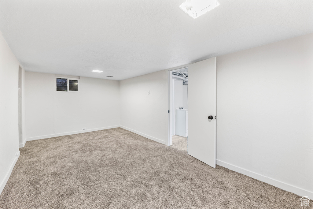 Finished basement featuring light colored carpet and baseboards