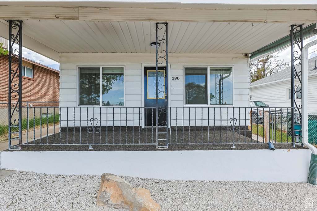 Exterior space with a porch and fence