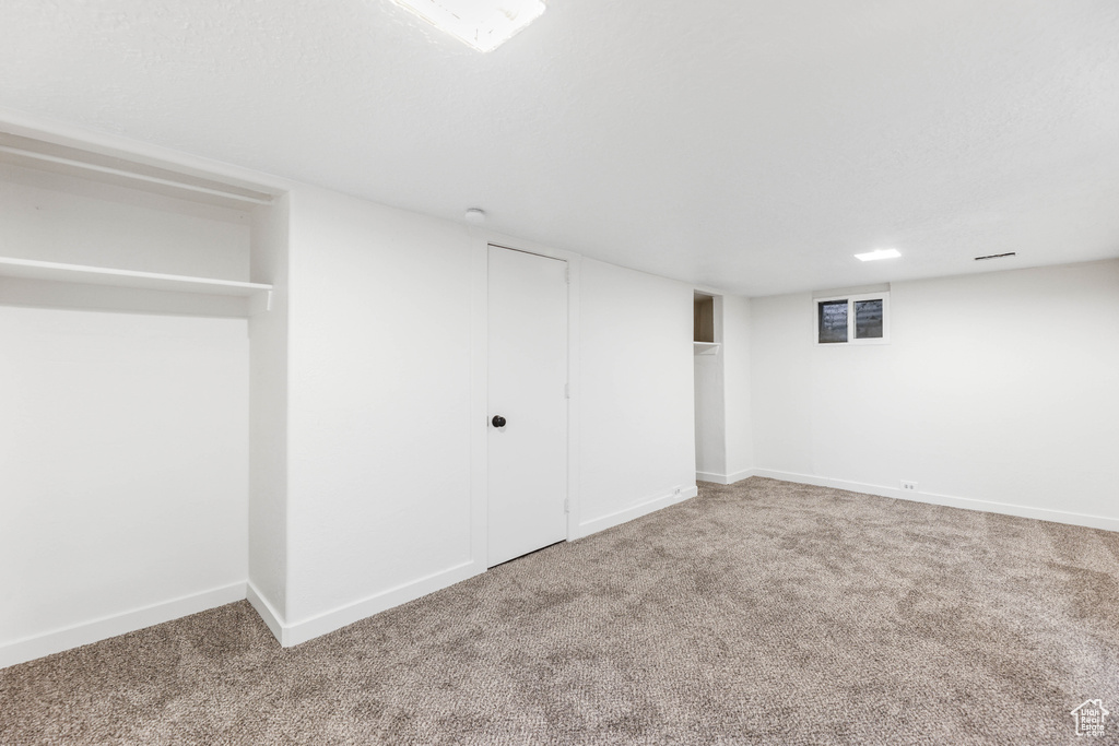 Finished basement featuring baseboards and carpet