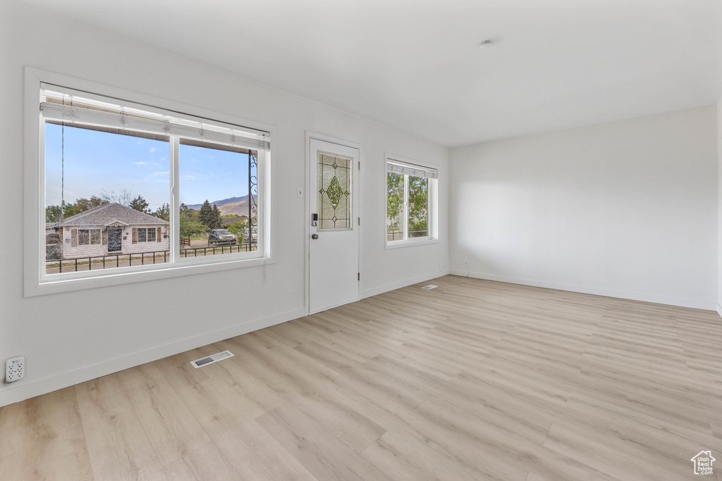 Interior space featuring light wood-style flooring, baseboards, and visible vents