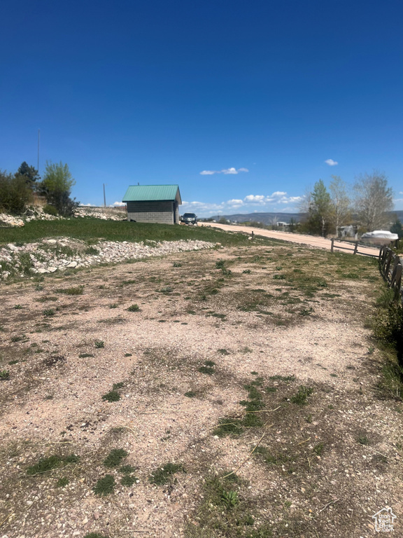 View of yard featuring a rural view and an outdoor structure