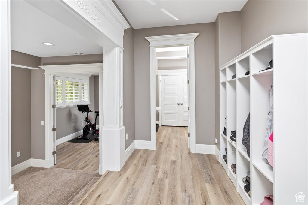 Mudroom with baseboards and light wood-type flooring