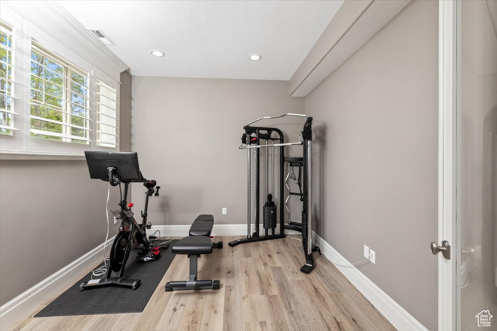 Workout room featuring baseboards, recessed lighting, visible vents, and wood finished floors