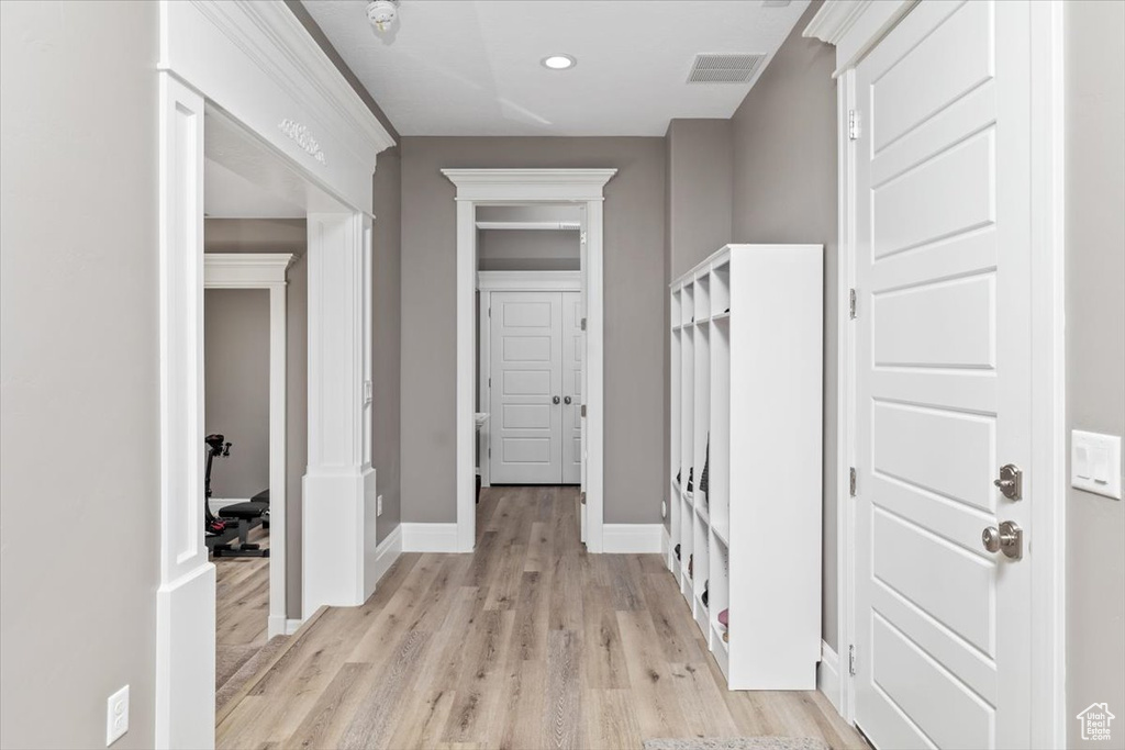 Interior space featuring baseboards, light wood-type flooring, visible vents, and recessed lighting