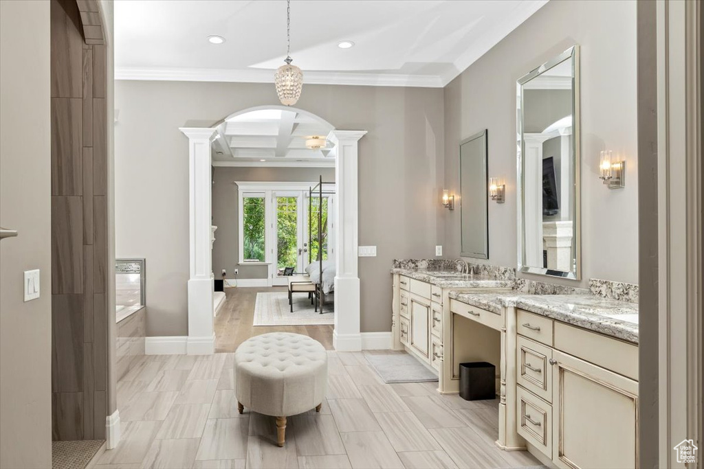 Bathroom with recessed lighting, coffered ceiling, ornamental molding, decorative columns, and a bathing tub