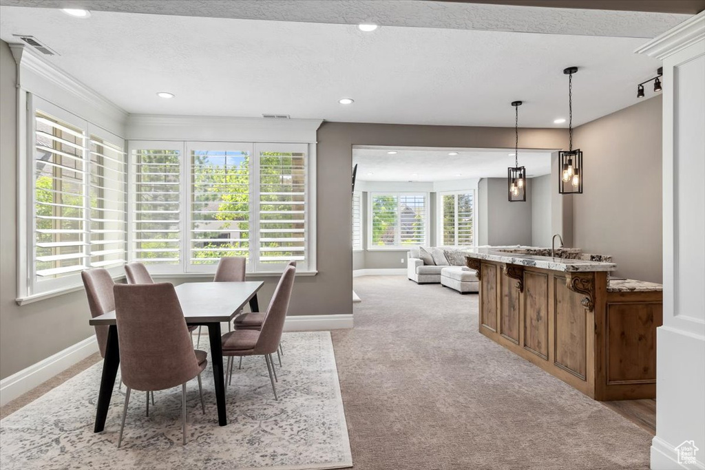 Dining space with light carpet, baseboards, visible vents, and recessed lighting