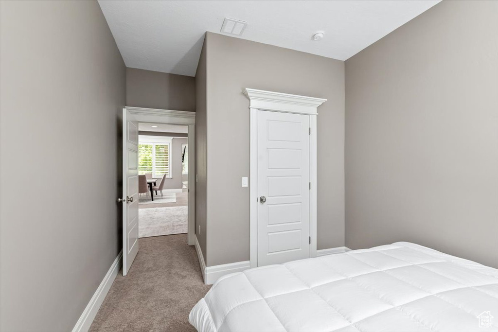 Bedroom featuring visible vents, baseboards, and carpet floors