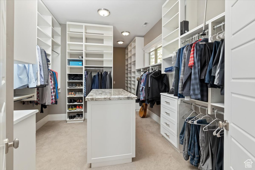 Walk in closet featuring light colored carpet and visible vents