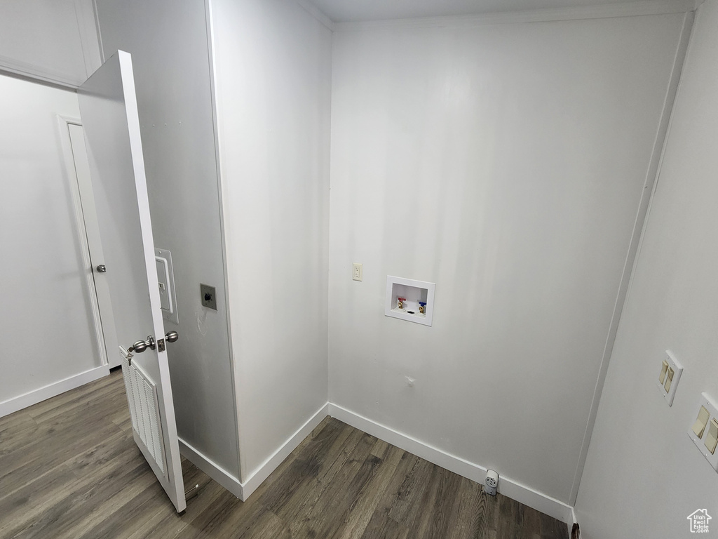 Clothes washing area featuring laundry area, dark wood-style floors, electric dryer hookup, baseboards, and hookup for a washing machine