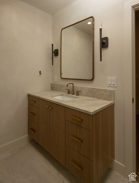 Bathroom with vanity and baseboards