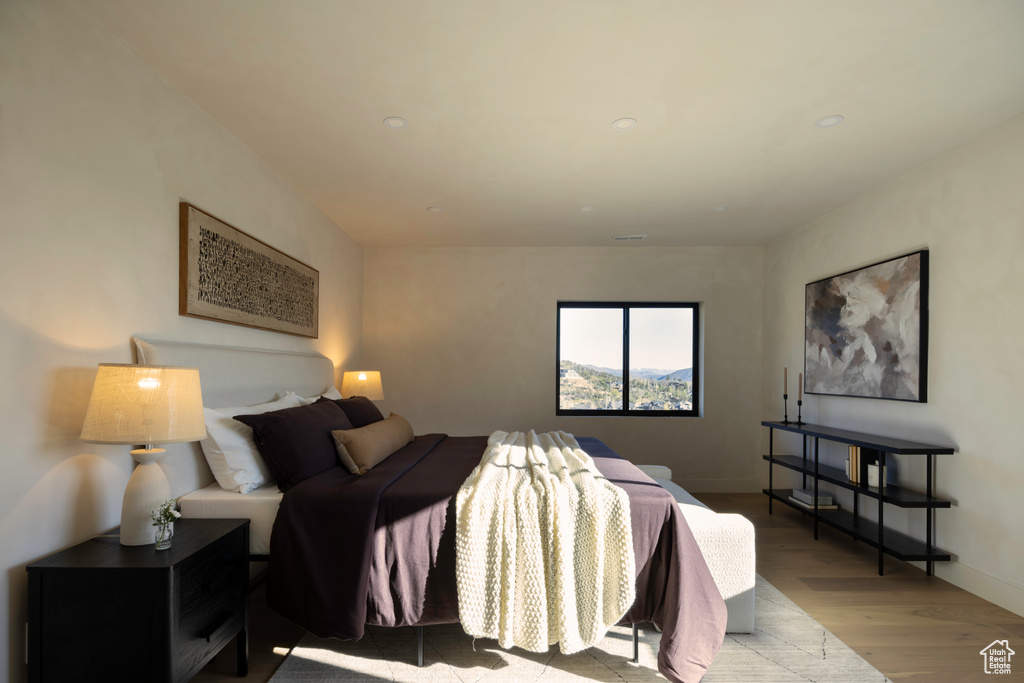 Bedroom with recessed lighting, baseboards, and wood finished floors