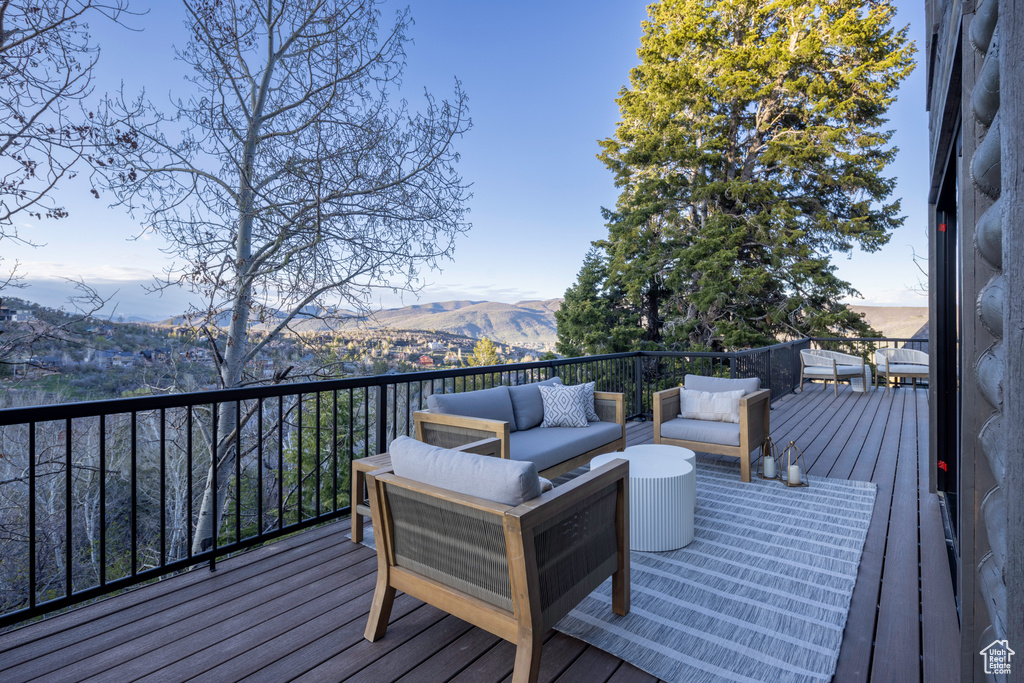 Deck featuring a mountain view and outdoor lounge area