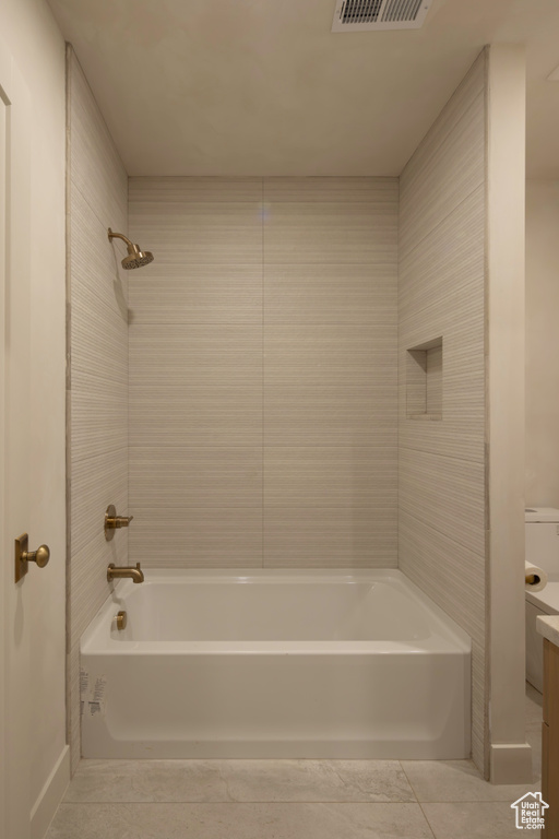 Bathroom with tile patterned flooring, shower / tub combination, visible vents, and vanity