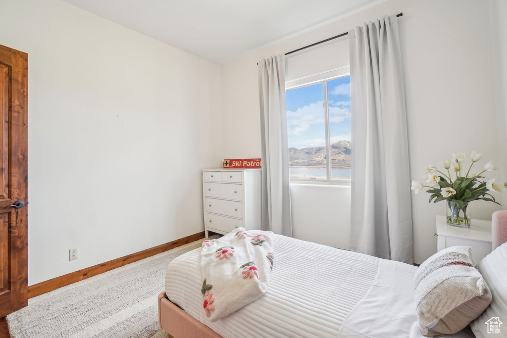 Bedroom featuring a water view and baseboards