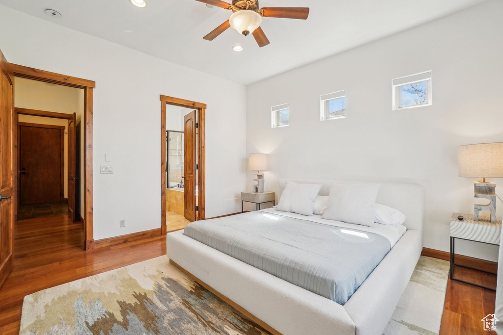 Bedroom featuring connected bathroom, wood finished floors, baseboards, and recessed lighting