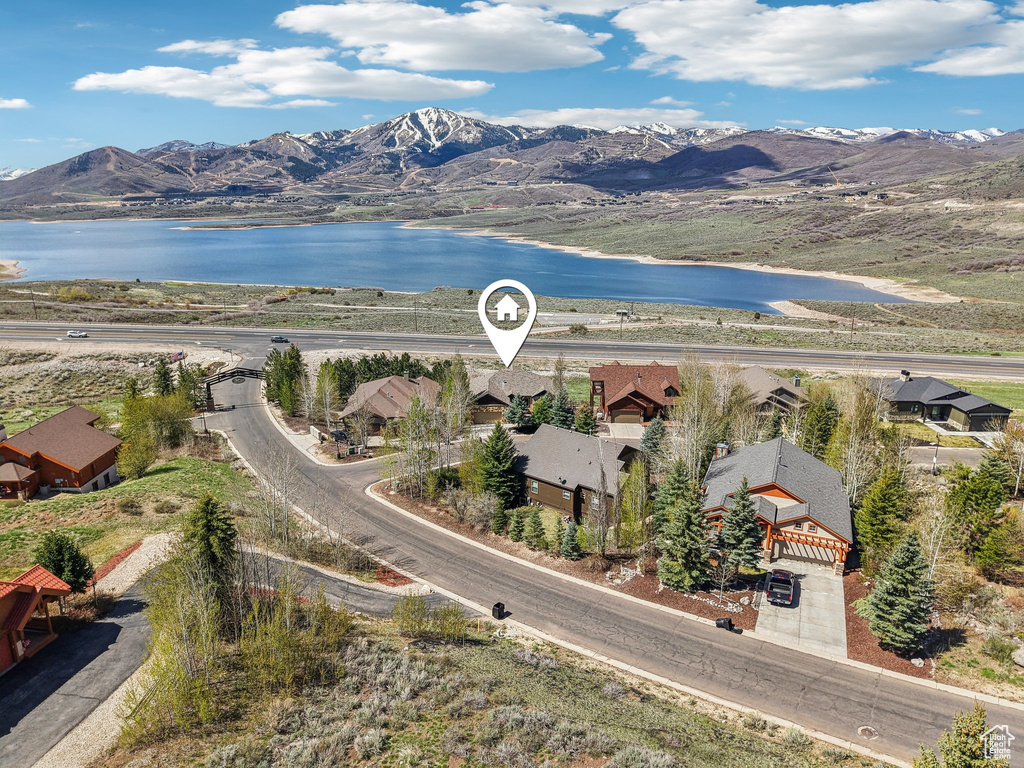 Drone / aerial view featuring a water and mountain view