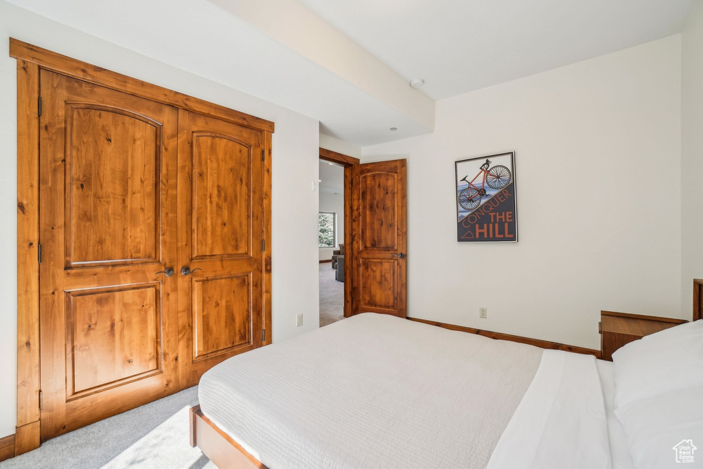 Carpeted bedroom featuring baseboards