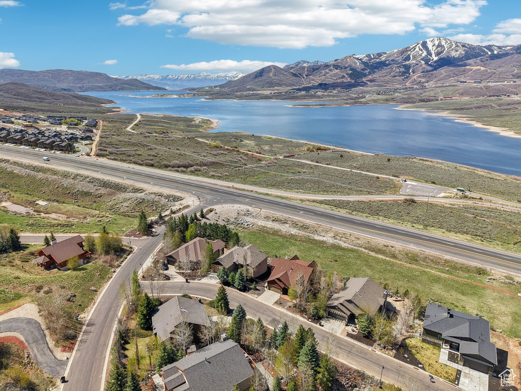 Birds eye view of property with a water and mountain view and a residential view