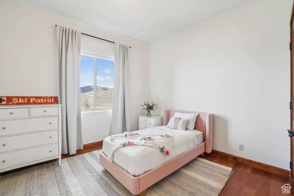 Bedroom with baseboards and wood finished floors