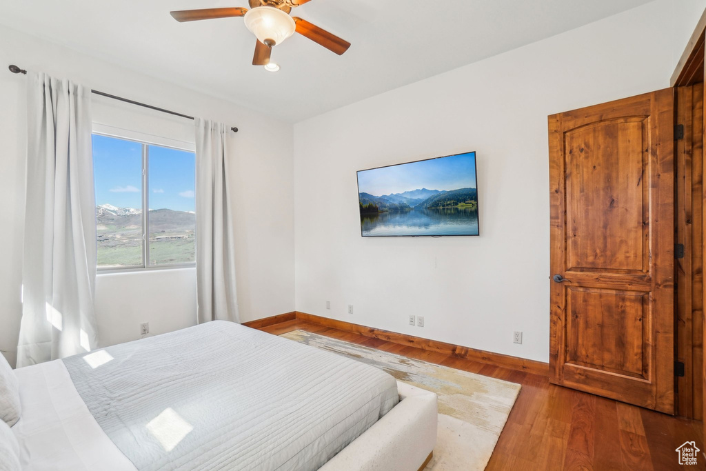 Bedroom with baseboards, a ceiling fan, and wood finished floors