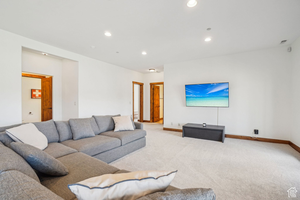 Carpeted living room with baseboards and recessed lighting