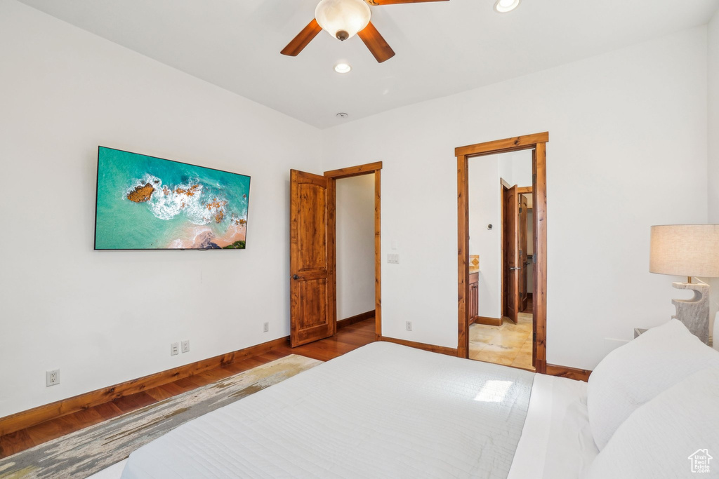Bedroom with a ceiling fan, recessed lighting, baseboards, ensuite bath, and wood finished floors