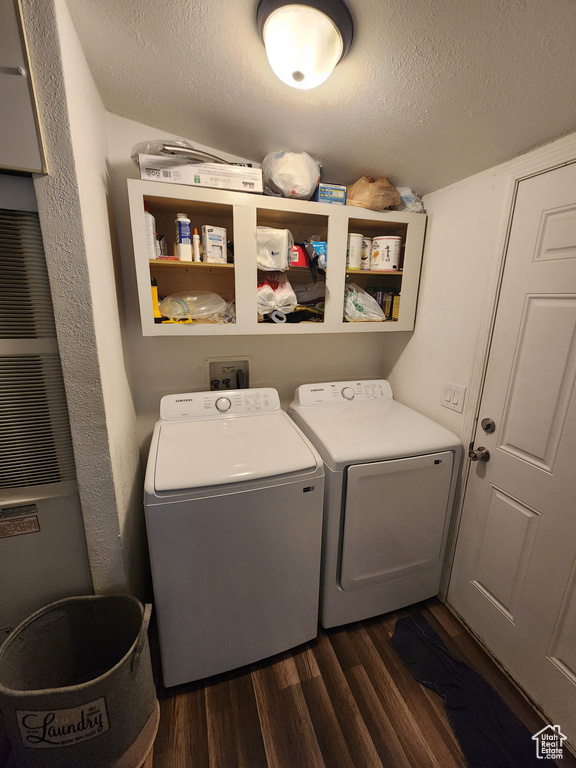 Laundry room featuring separate washer and dryer, laundry area, a textured ceiling, and dark wood-type flooring