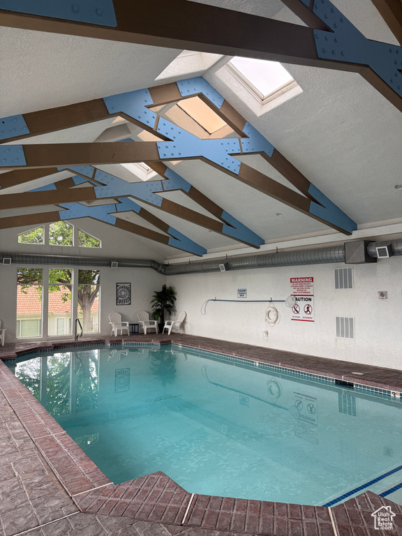 Community pool featuring a skylight