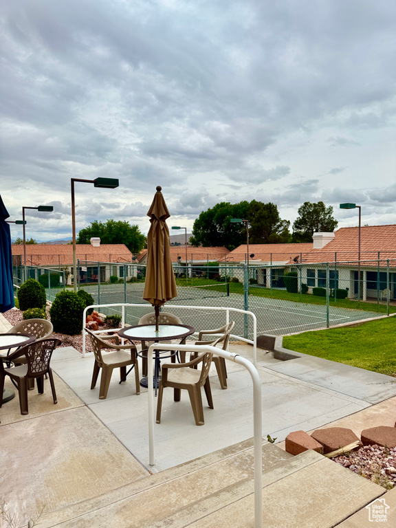 Surrounding community featuring outdoor dining space, fence, and a patio
