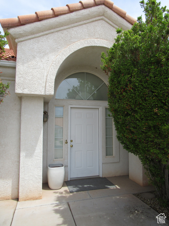 Entrance to property featuring stucco siding
