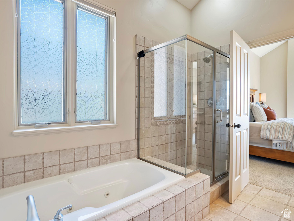Ensuite bathroom with tile patterned floors, a tub with jets, ensuite bath, and a shower stall