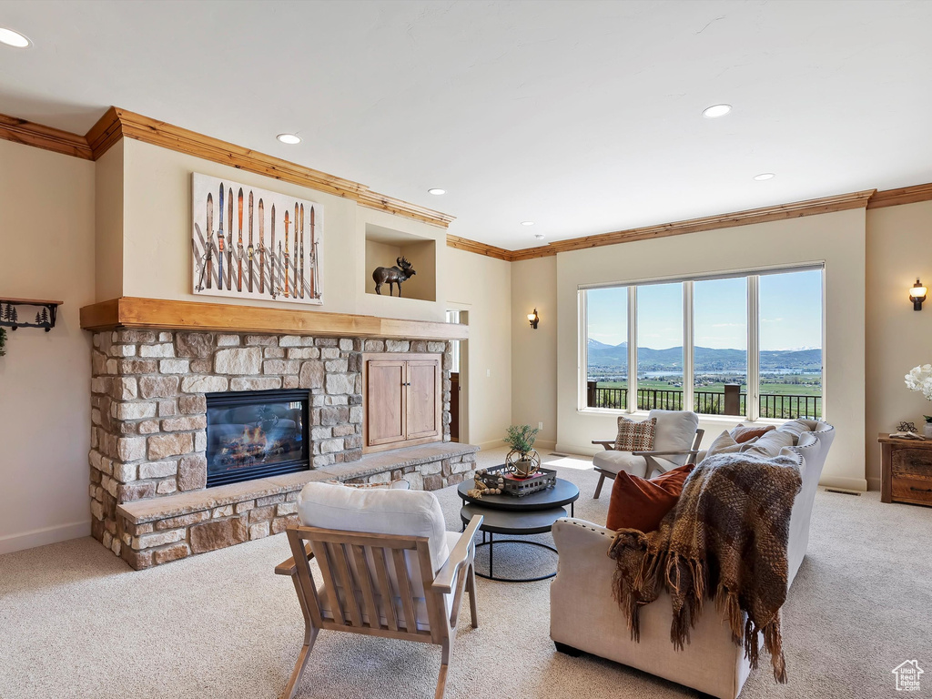 Living area featuring light colored carpet, ornamental molding, and recessed lighting