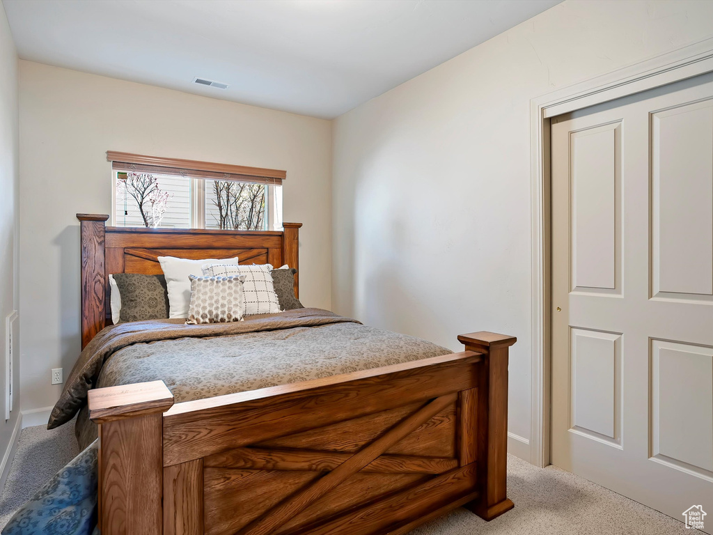 Carpeted bedroom featuring visible vents