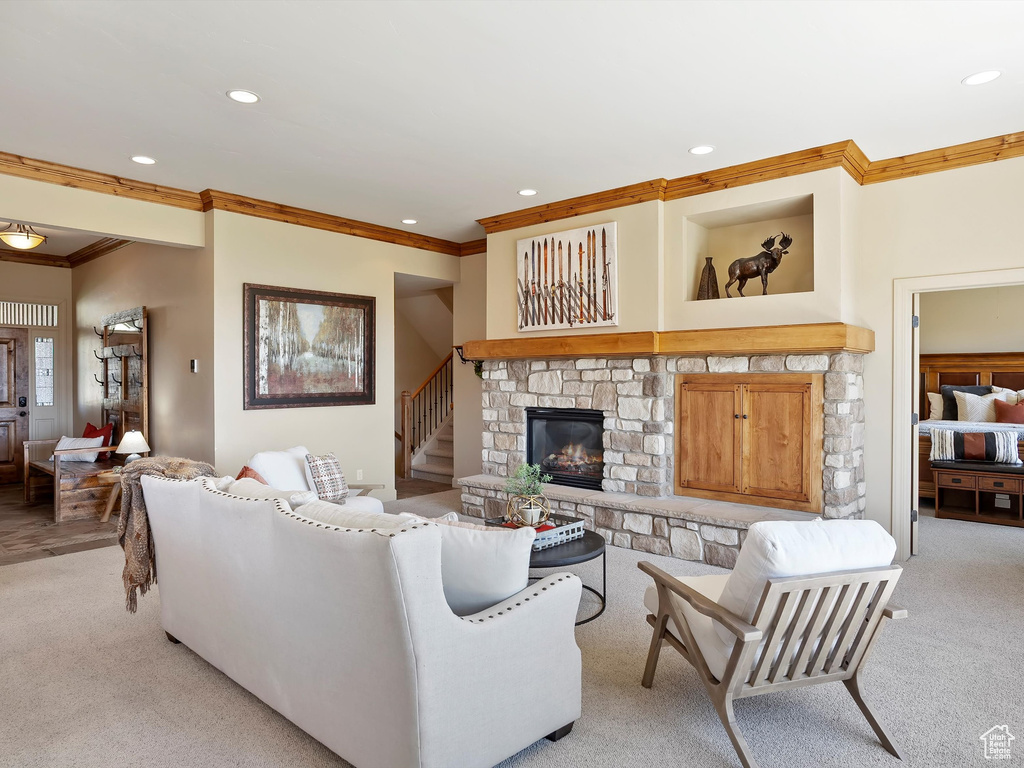 Living area with recessed lighting, light carpet, and crown molding