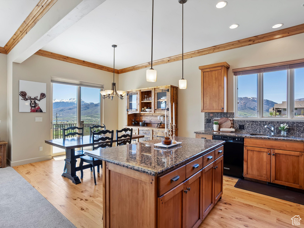 Kitchen featuring a sink, a mountain view, ornamental molding, dishwasher, and an inviting chandelier